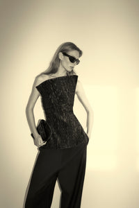 Styled view CAMILLA AND MARC Elise Top in Black with sculpted fit, off‑shoulder design and side hem splits.