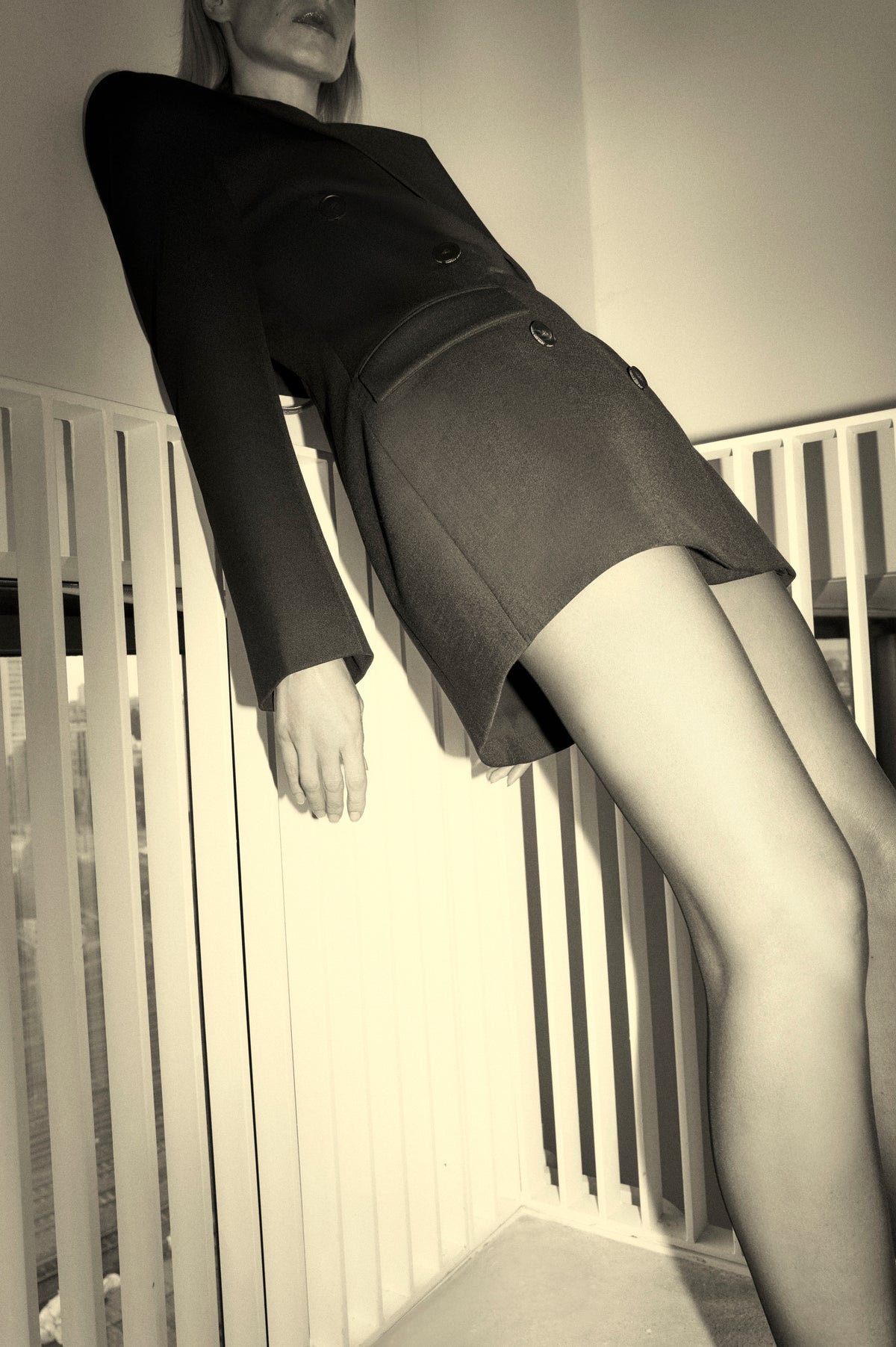 Close up view CAMILLA AND MARC Cassie long sleeve mini dress in black with open back removable chain detail.