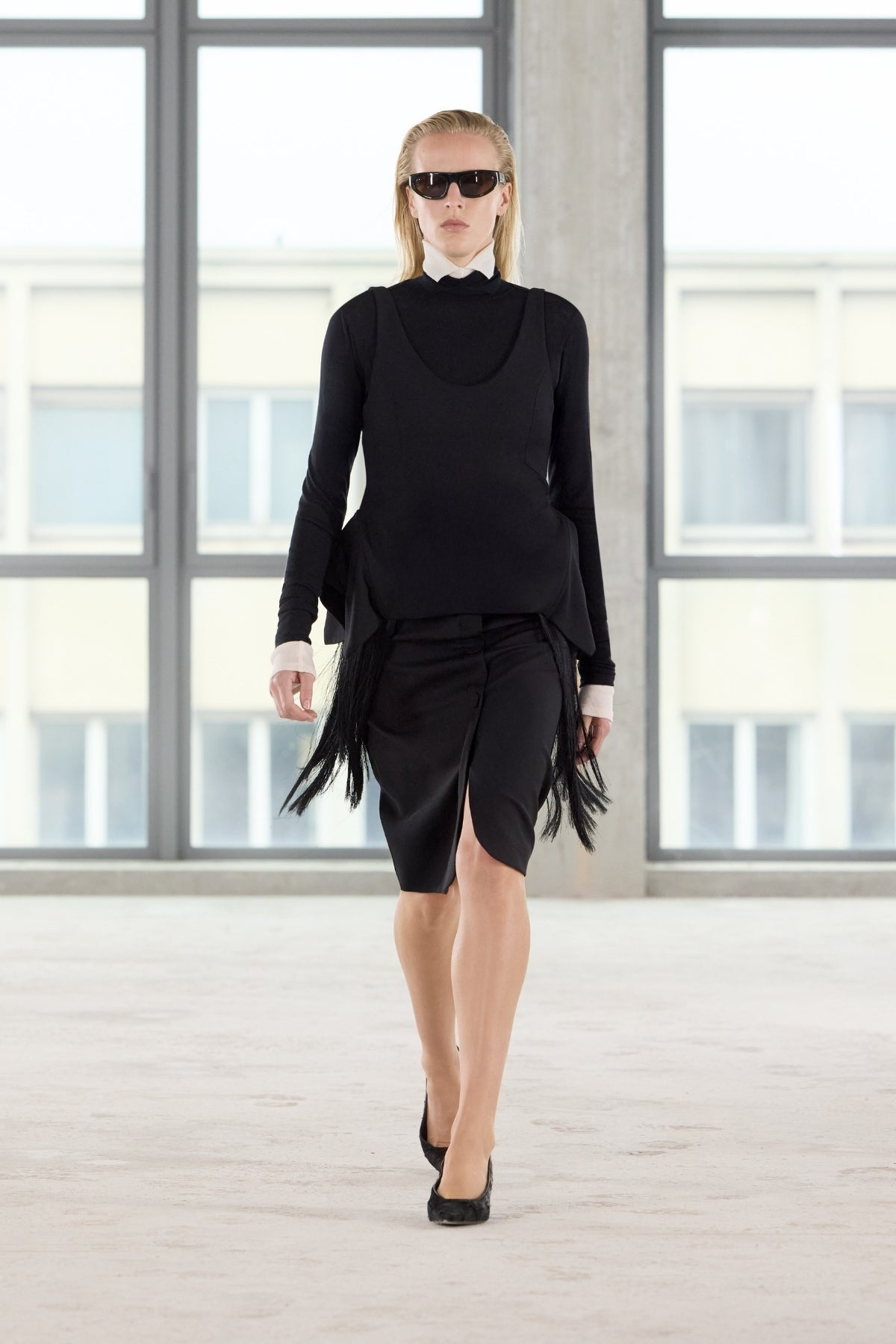 Front runway view CAMILLA AND MARC Zaman Top in Black with a structured sleeveless design and detachable hem fringe.