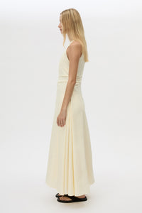 Side view CAMILLA AND MARC Brera midi dress in pale yellow with topstitch details and side pockets.