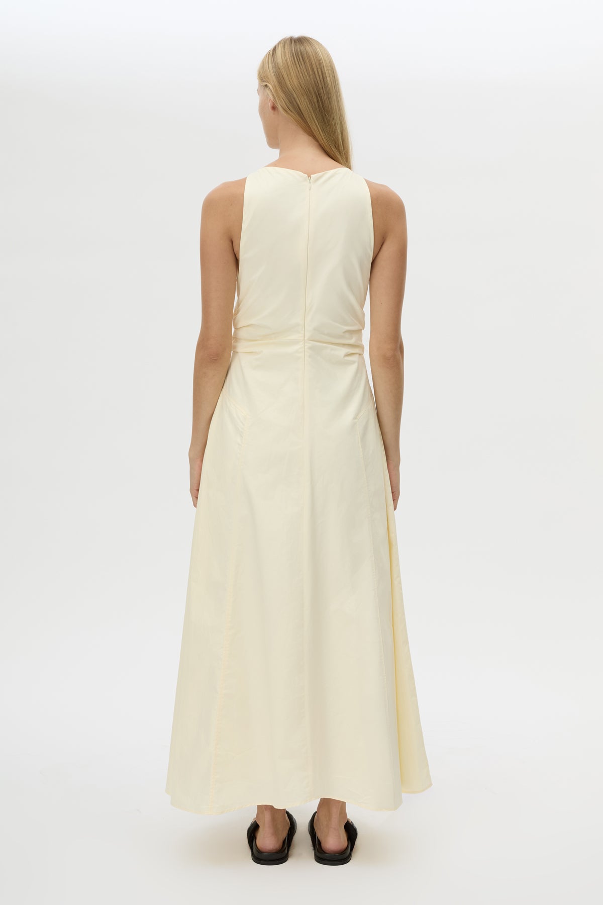 Back view CAMILLA AND MARC Brera midi dress in pale yellow with topstitch details and side pockets.
