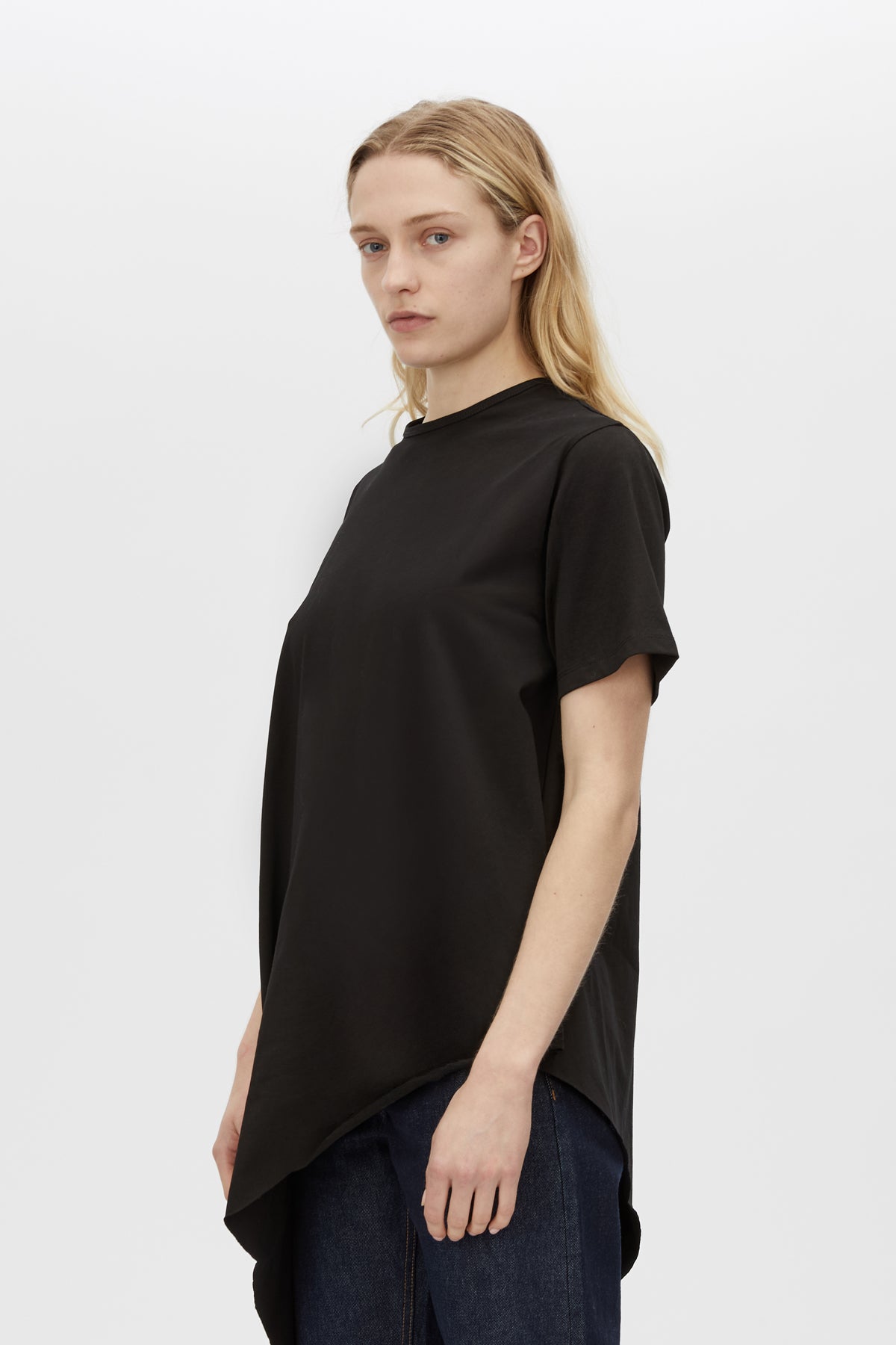 Cropped view CAMILLA AND MARC Clarity draped oversized asymmetric tee in black with raw hemline and internal french seams.