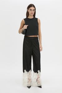Front-styled view CAMILLA AND MARC wide-leg Alvar Lace Pant in black and white stripe with scalloped lace hem.