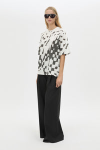 Three-quarter view CAMILLA AND MARC Asper Print Tee in Soft White with oversized short‑sleeve silhouette and printed artwork. 
