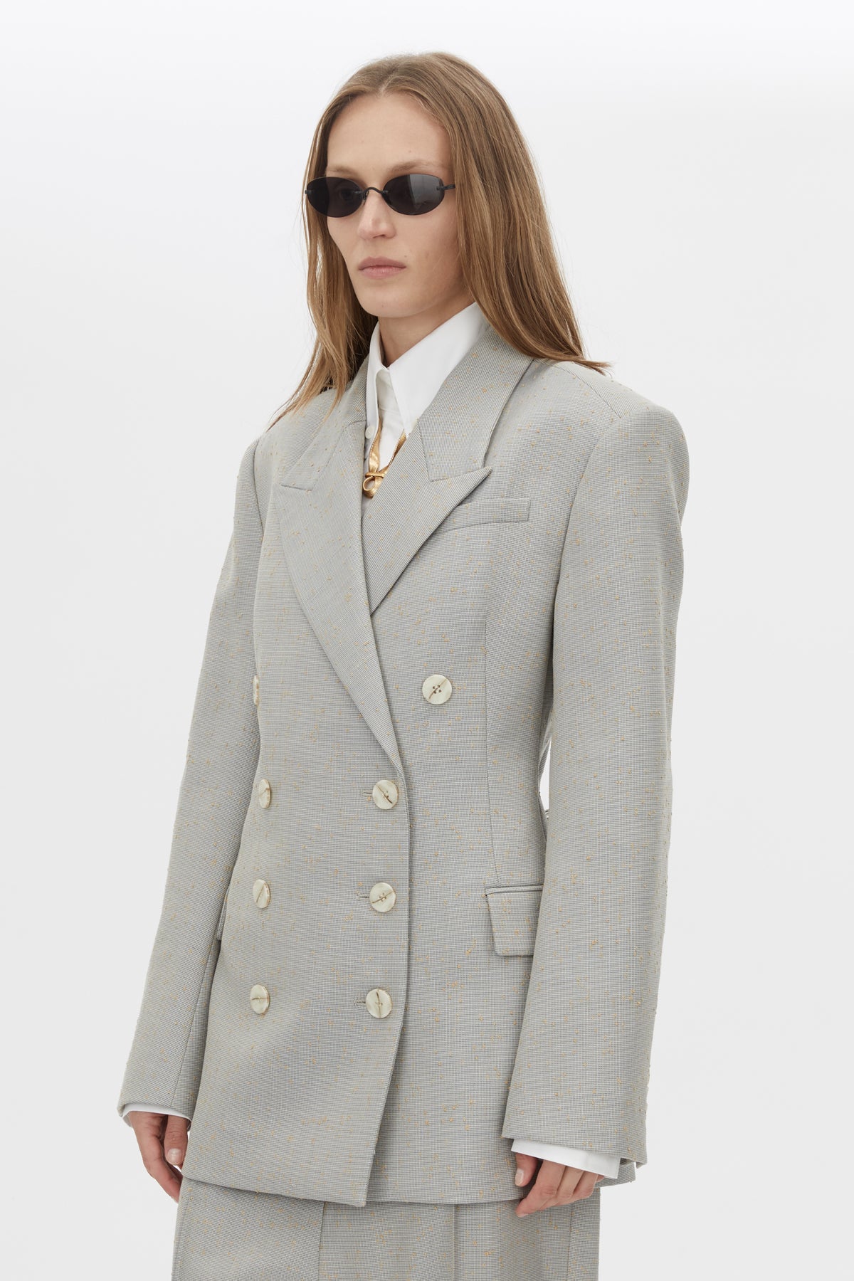 Three-quarter view CAMILLA AND MARC Aspira Blazer in Dusty Blue with a draped double‑breasted wool silhouette.