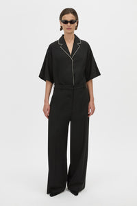 Front Styled View - CAMILLA AND MARC Atticus Pant in black with a low-rise, wide leg silhouette. 