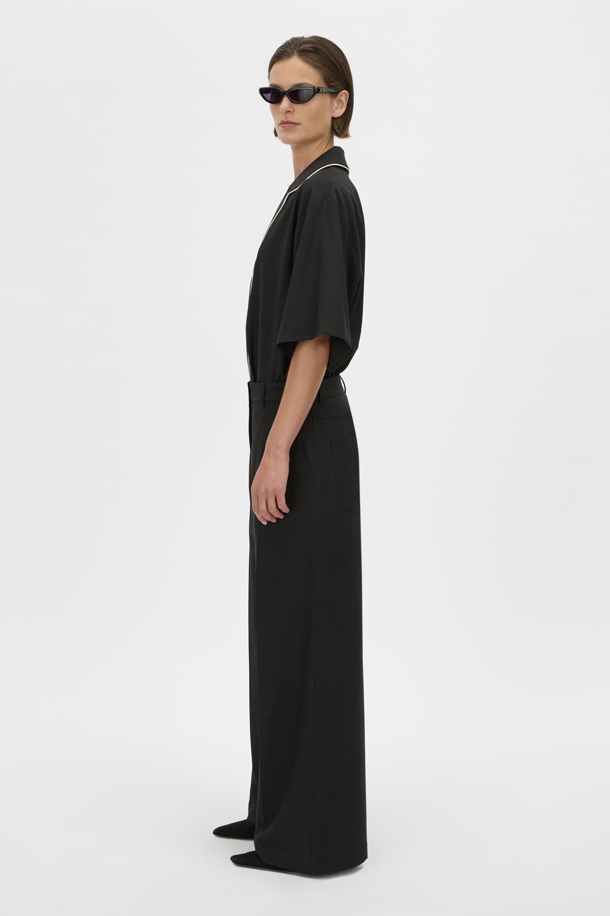 Side View - CAMILLA AND MARC Atticus Pant in black with a low-rise, wide leg silhouette. 