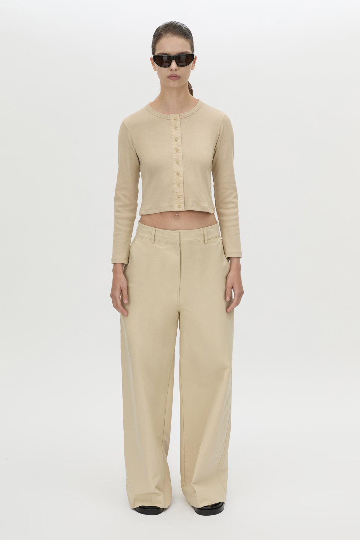 Front styled view CAMILLA AND MARC Aubrey Long Sleeve Rib Top in Latte with a contrast corozo button placket.