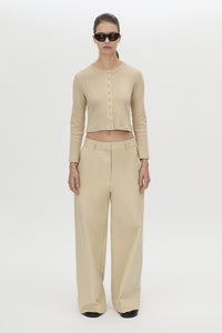 Front styled view CAMILLA AND MARC Aubrey Long Sleeve Rib Top in Latte with a contrast corozo button placket.