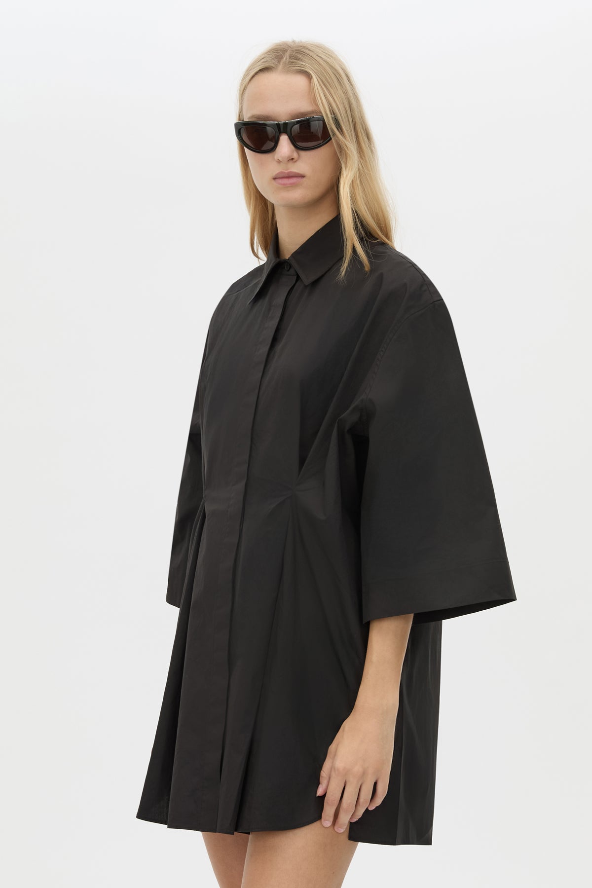 Cropped View CAMILLA AND MARC Avant collared black shirt dress with front symmetric pleat details. 