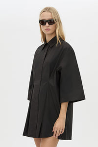 Cropped View CAMILLA AND MARC Avant collared black shirt dress with front symmetric pleat details. 