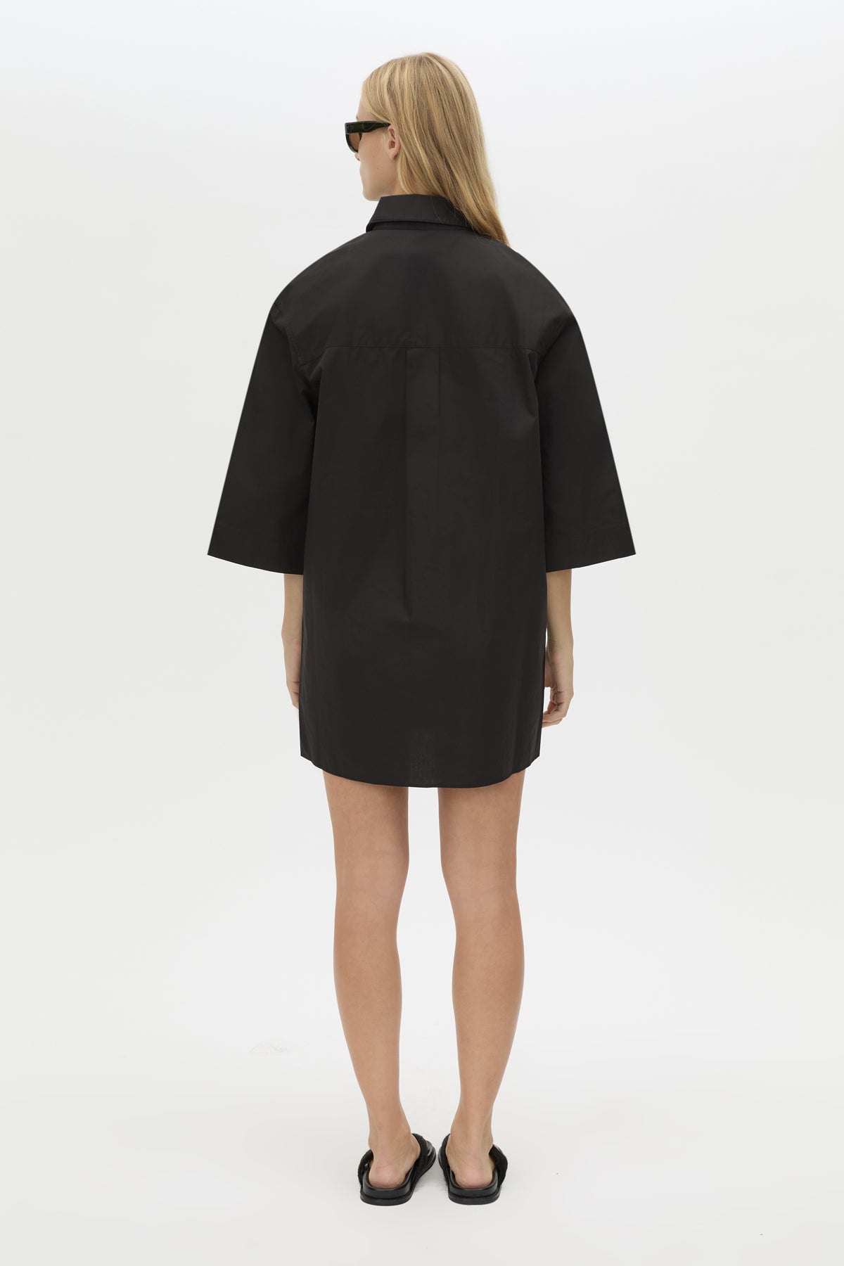 Back View CAMILLA AND MARC Avant collared black shirt dress with front symmetric pleat details. 