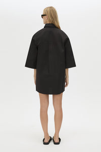 Back View CAMILLA AND MARC Avant collared black shirt dress with front symmetric pleat details. 