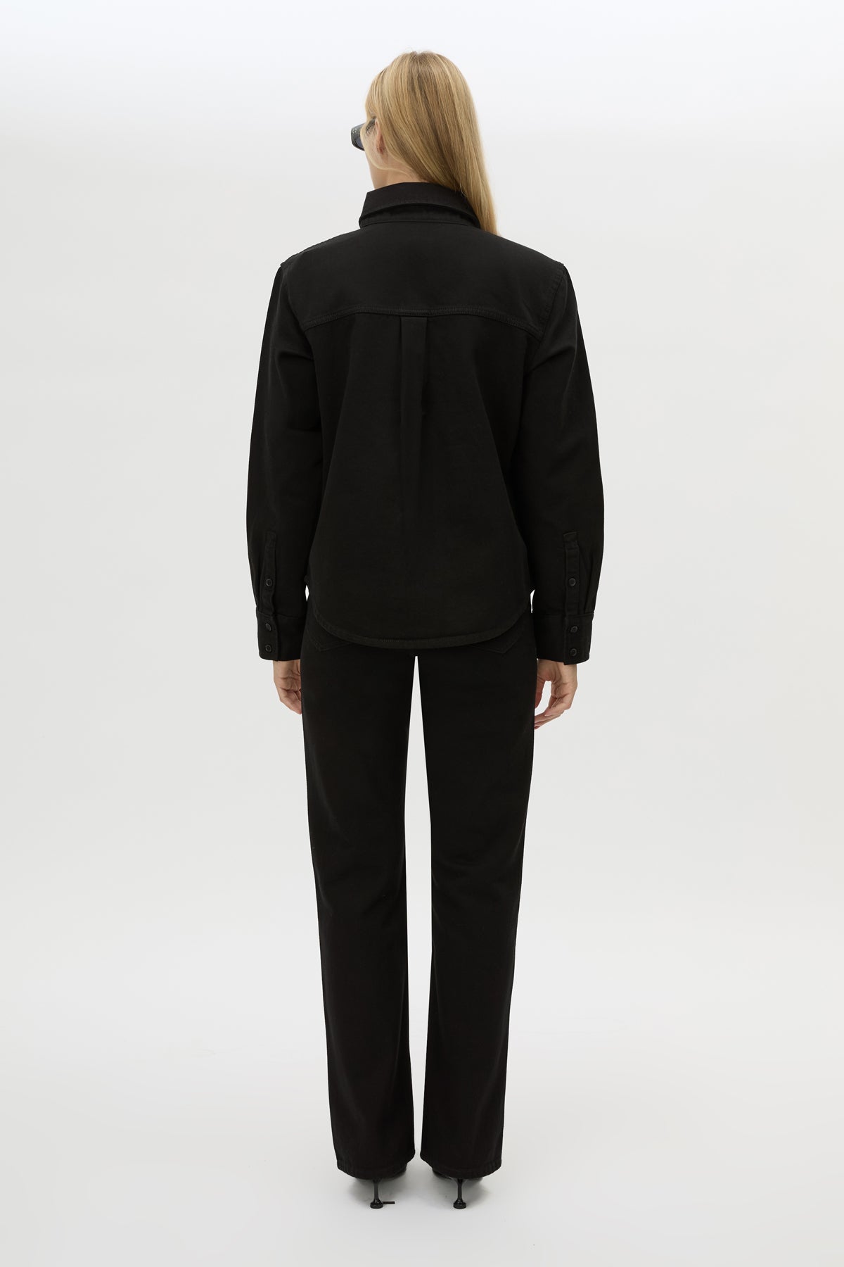 Back view CAMILLA AND MARC Caden Denim Shirt in True Black with shoulder pads and embroidered monogram detailing.