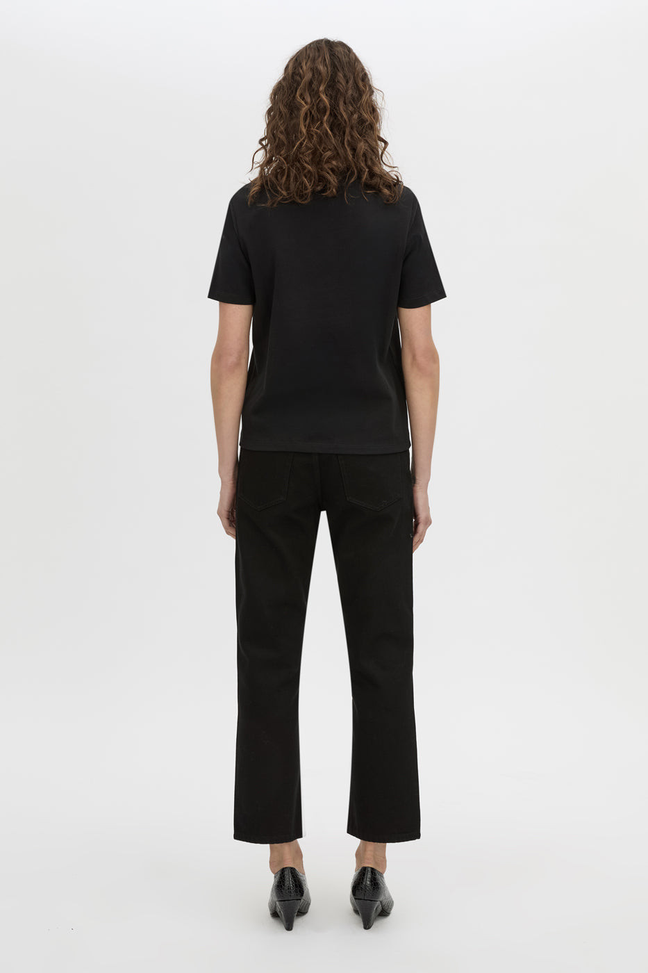 Back view CAMILLA AND MARC short sleeve Carmen Shoulder Pad Tee in black with strong shoulder design. 