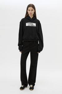 Front view CAMILLA AND MARC Carmont Graphic Hoodie in Black with boxy fit and black graphic logo.