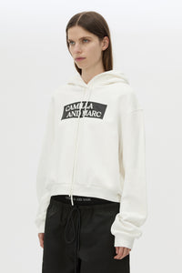 Cropped view CAMILLA AND MARC Carmont Graphic Hoodie in Soft White with boxy fit and black graphic logo.