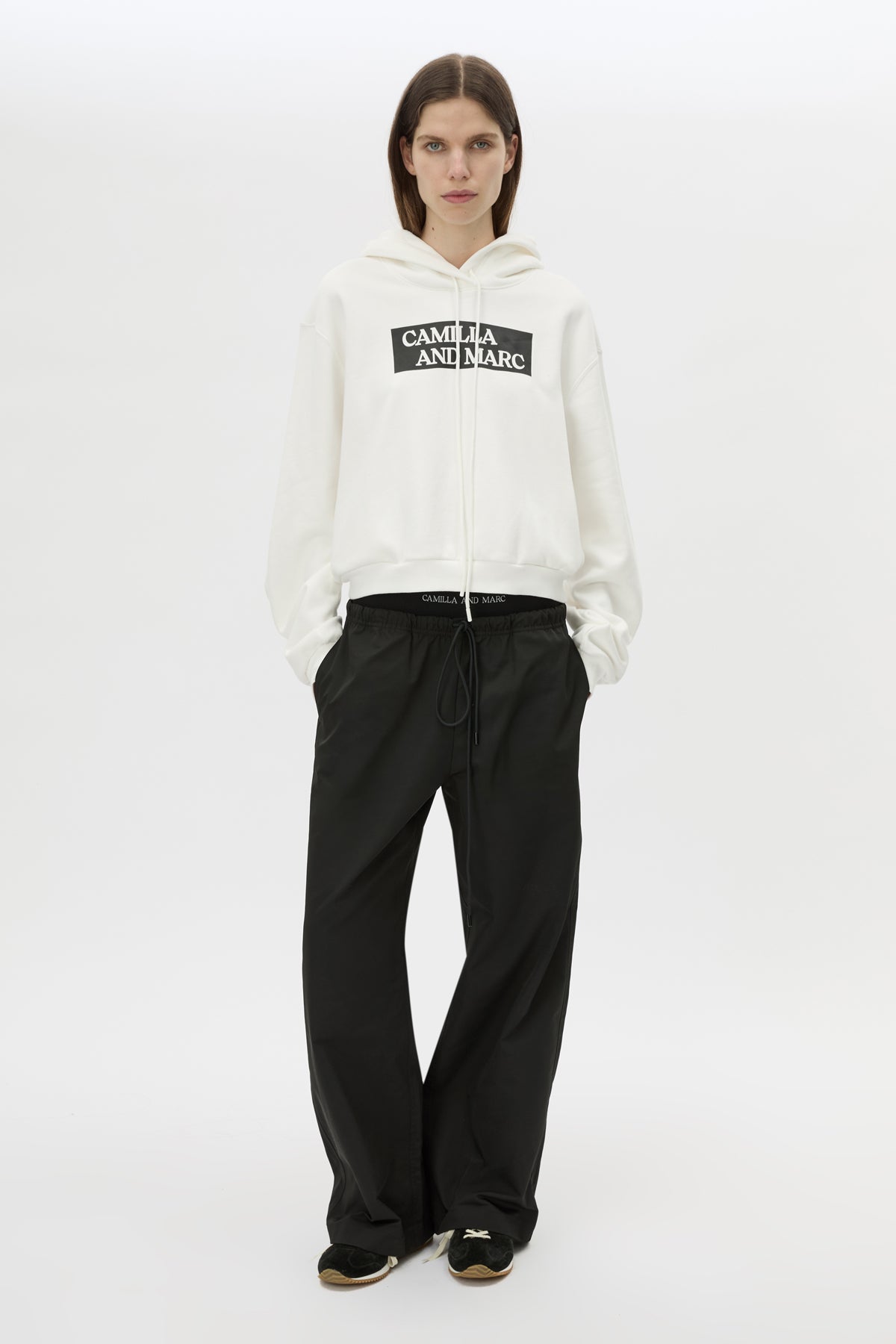 Front styled view CAMILLA AND MARC Carmont Graphic Hoodie in Soft White with boxy fit and black graphic logo.