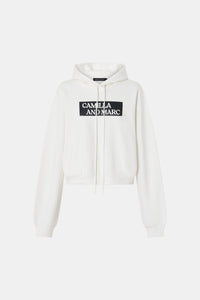 Ghost view CAMILLA AND MARC Carmont Graphic Hoodie in Soft White with boxy fit and black graphic logo.