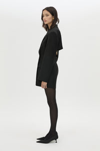 Side view CAMILLA AND MARC Cassie long sleeve mini dress in black with open back removable chain detail.