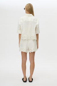 Back view CAMILLA AND MARC Chara Embroidered Cropped Shirt in Cream with short sleeves, lace hem and slight A‑line fit.