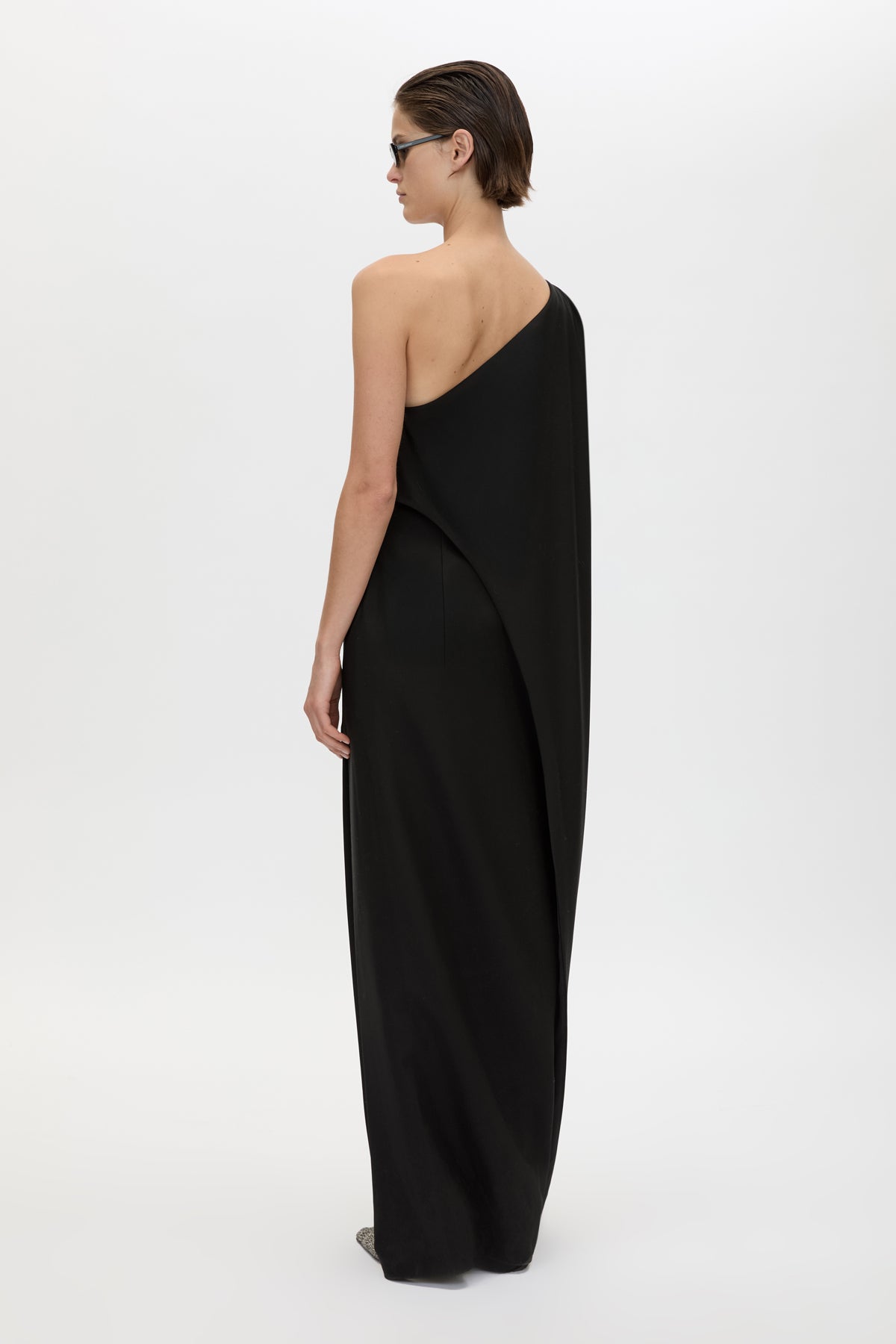 Back view CAMILLA AND MARC Ciran Asymmetric Maxi Dress in Black with one‑shoulder padded detail and 100% wool fabrication.