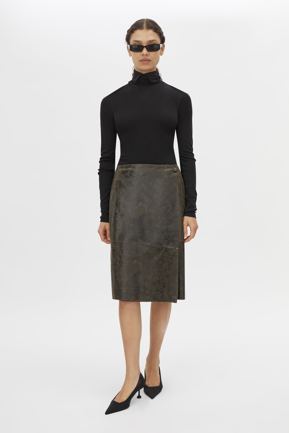 Front styled view CAMILLA AND MARC Dawn Leather Skirt in Black Brown with a wrap midi silhouette.