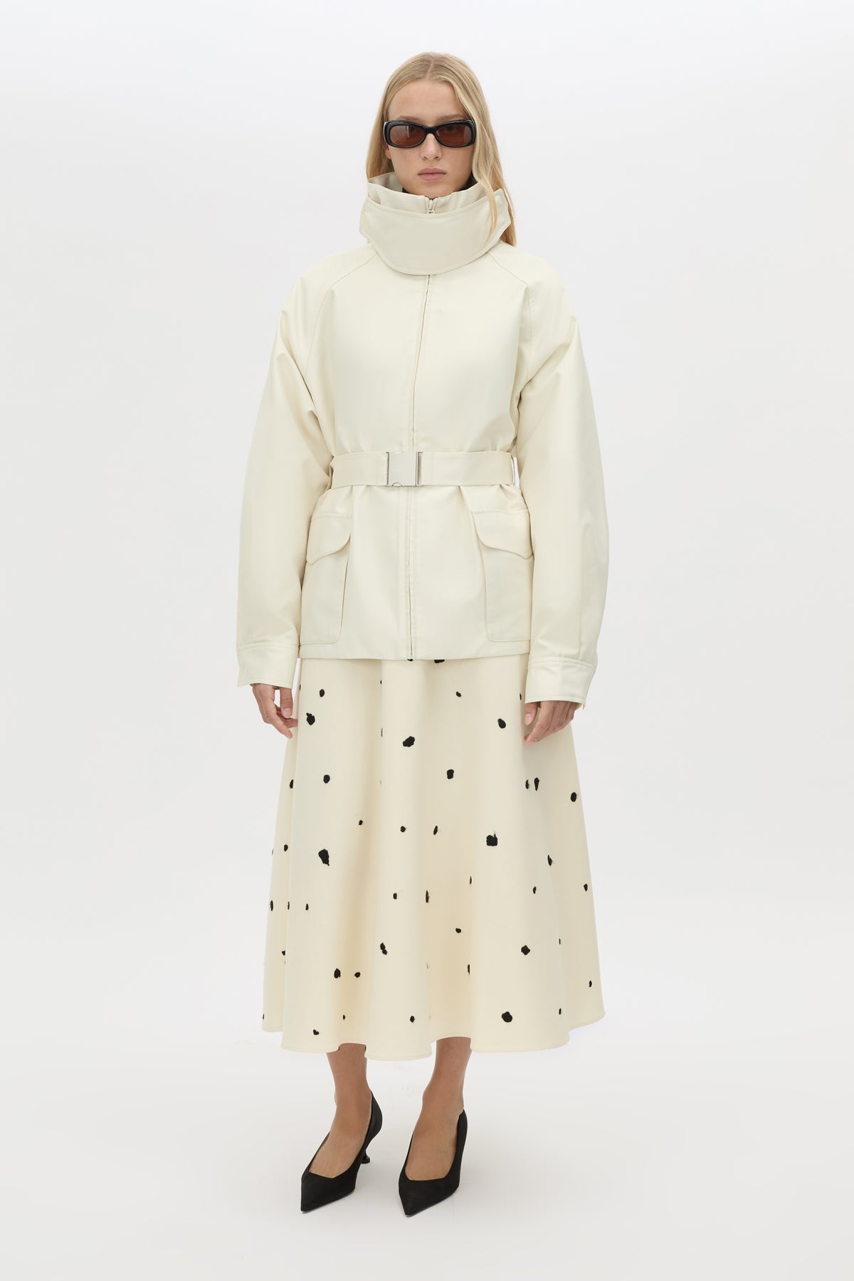Front view CAMILLA AND MARC Drea funnel neck puffer jacket in cream with utility waistbelt and detachable throat latch.