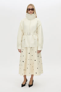 Front view CAMILLA AND MARC Drea funnel neck puffer jacket in cream with utility waistbelt and detachable throat latch.