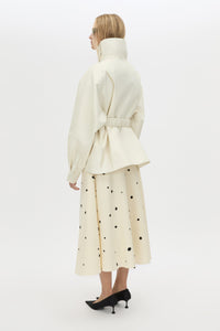 Back view CAMILLA AND MARC Drea funnel neck puffer jacket in cream with utility waistbelt and detachable throat latch.