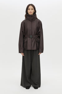 Front styled view CAMILLA AND MARC Drea Puffer Jacket in Espresso Brown with funnel neck and padded puffer silhouette.