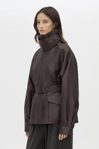 Cropped view CAMILLA AND MARC Drea Puffer Jacket in Espresso Brown with funnel neck and padded puffer silhouette.