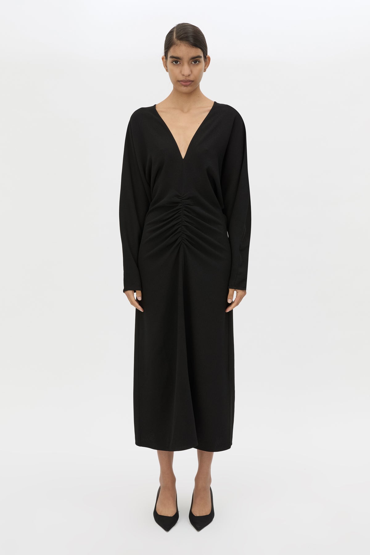 Front styled view CAMILLA AND MARC Dune Draped Waist Midi Dress in Black with gathered waist detailing.