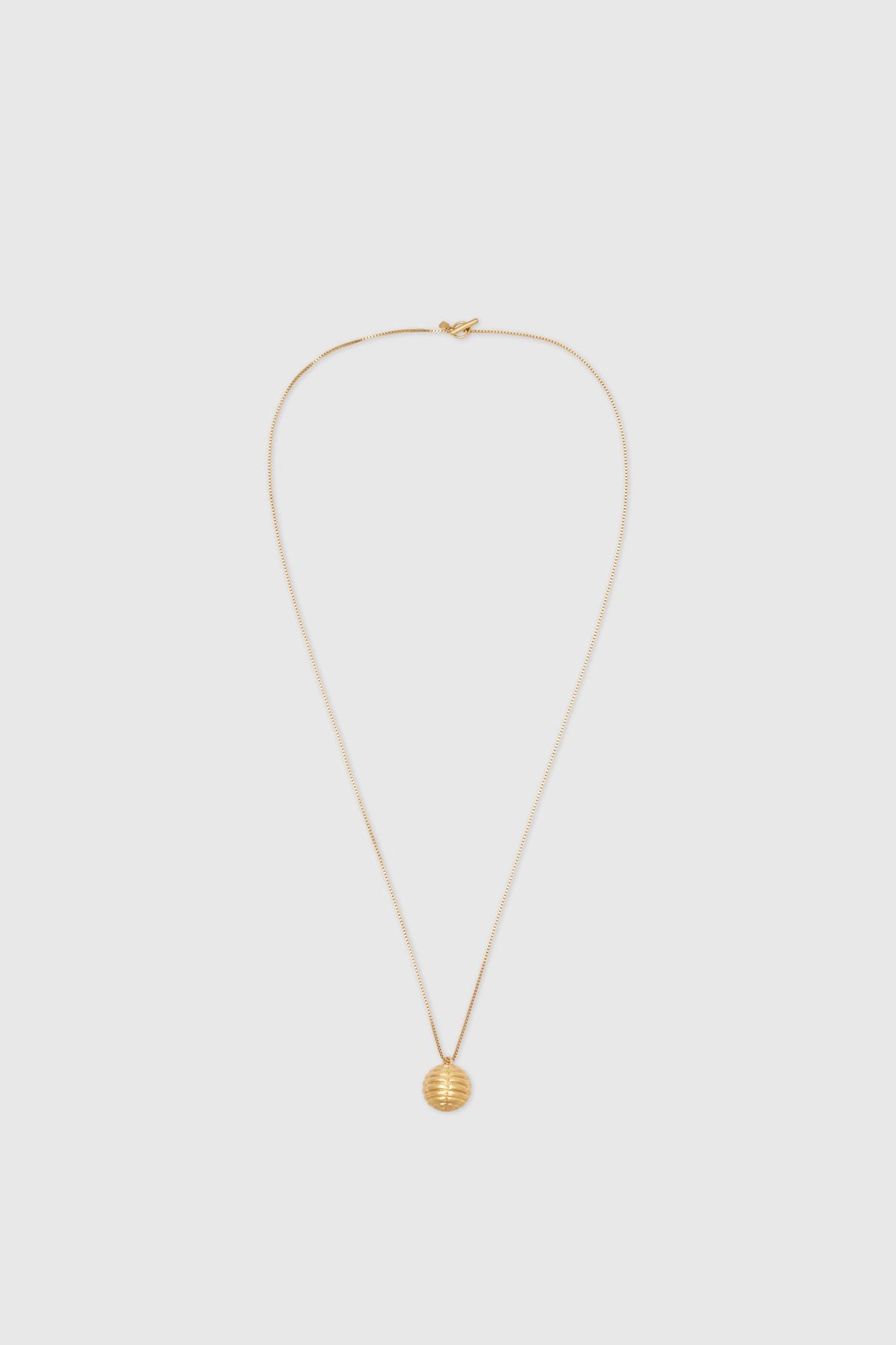 Ghost view CAMILLA AND MARC Eagan Pendant in gold with fine box chain and ruched textured sphere pendant.