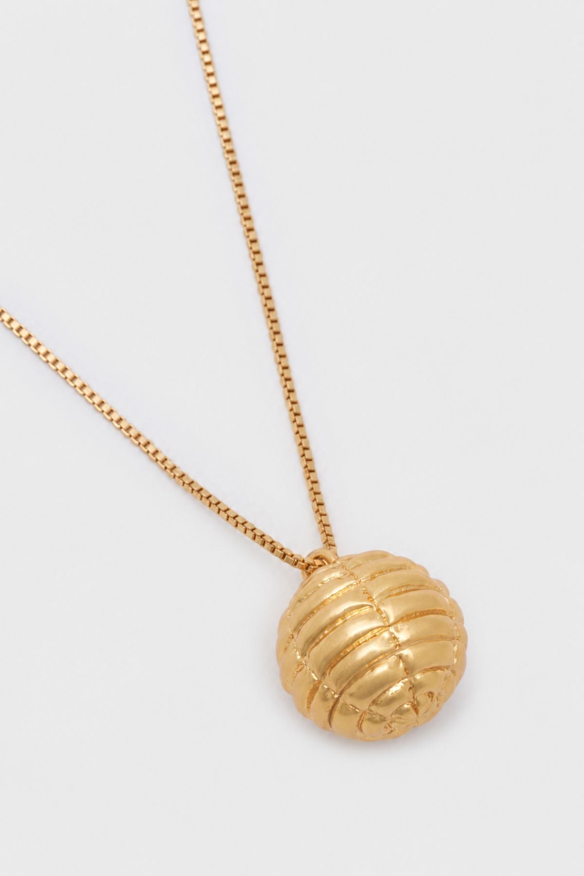 Ghost view CAMILLA AND MARC Eagan Pendant in gold with fine box chain and ruched textured sphere pendant.