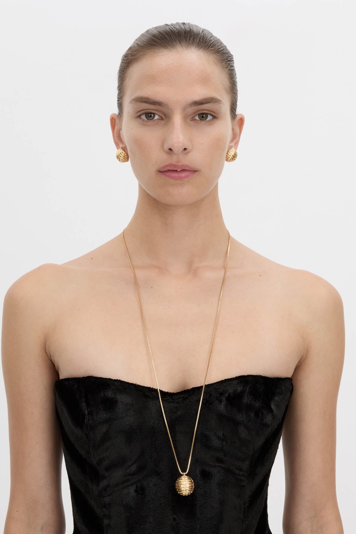 Front view CAMILLA AND MARC Eagan Pendant in gold with fine box chain and ruched textured sphere pendant.