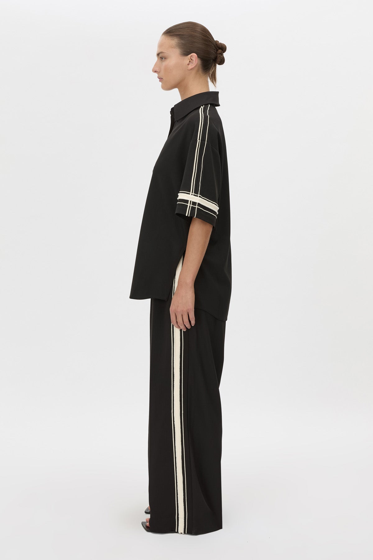 Side view CAMILLA AND MARC relaxed Enna Shirt in black with embroidery detail.