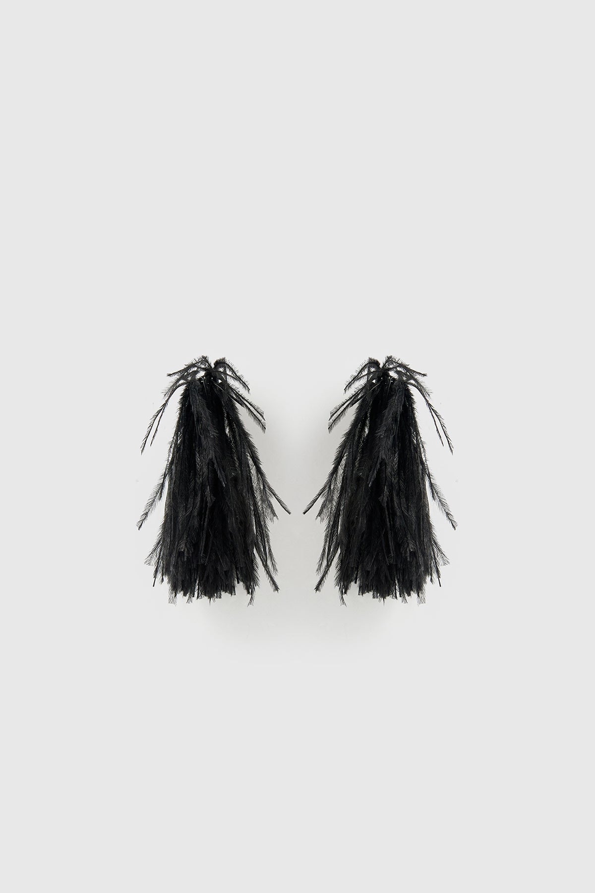 Front ghost view CAMILLA AND MARC Friesian Feather Earrings in Black featuring sculptural soft‑spike hoops fitted with black faux ostrich feathers.