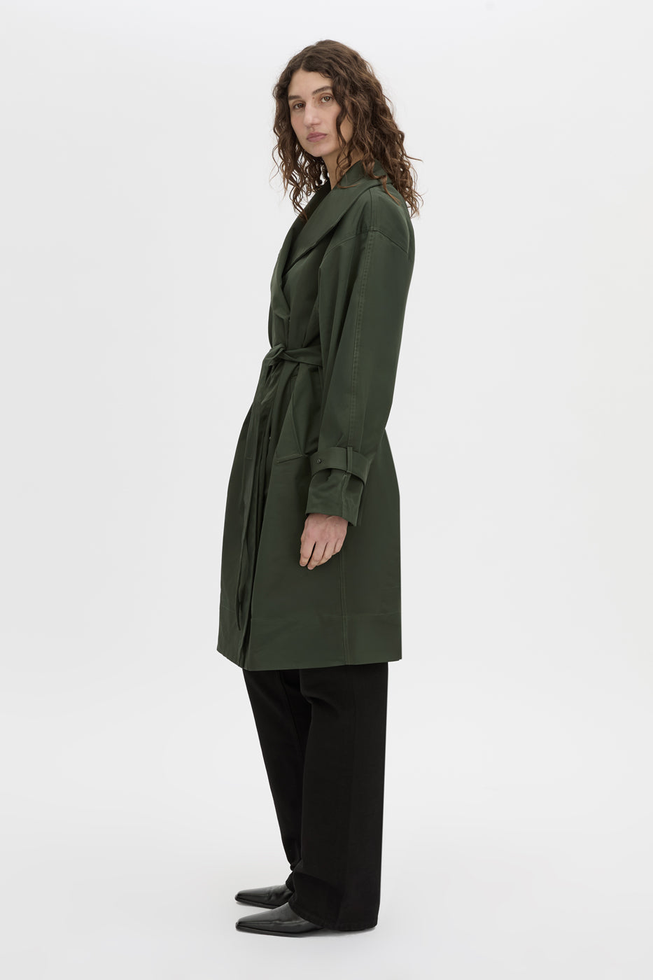 Side view CAMILLA AND MARC oversized Gia Funnel Neck Coat in bottle green with concealed double‑breasted front with internal snaps.