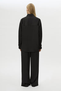 Back view CAMILLA AND MARC Ground Satin Long Sleeve Shirt in Black with collared neckline.
