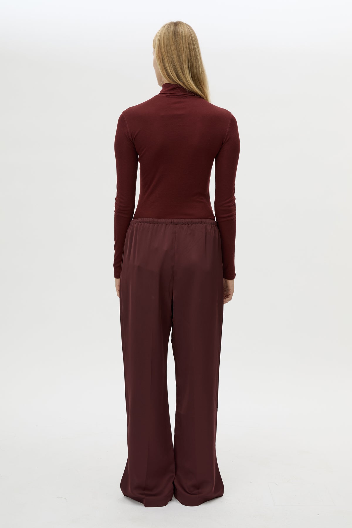Back view CAMILLA AND MARC Ground Satin Pant in Black with relaxed fit.