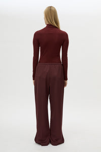 Back view CAMILLA AND MARC Ground Satin Pant in Black with relaxed fit.