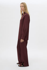 SIde view CAMILLA AND MARC Ground Satin Pant in Black with relaxed fit.