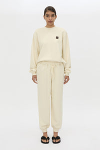 Front styled view CAMILLA AND MARC Idris Tracksuit Top in Ecru with folded rib crew neckline.