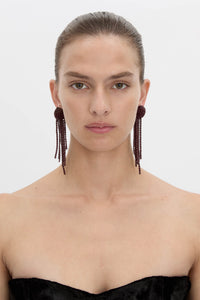 Front view CAMILLA AND MARC Irida Drop Earrings in burgundy with glossy beaded drop design.