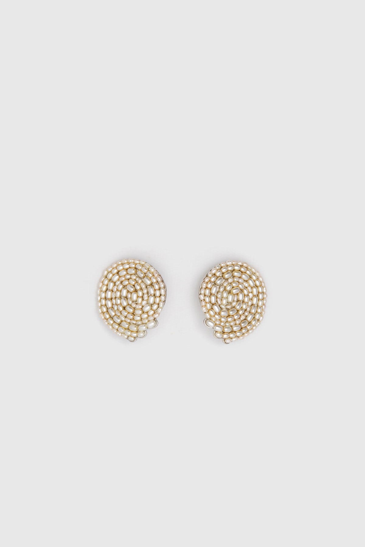 Ghost view CAMILLA AND MARC Irida Earrings in cream with spiral pearl design.