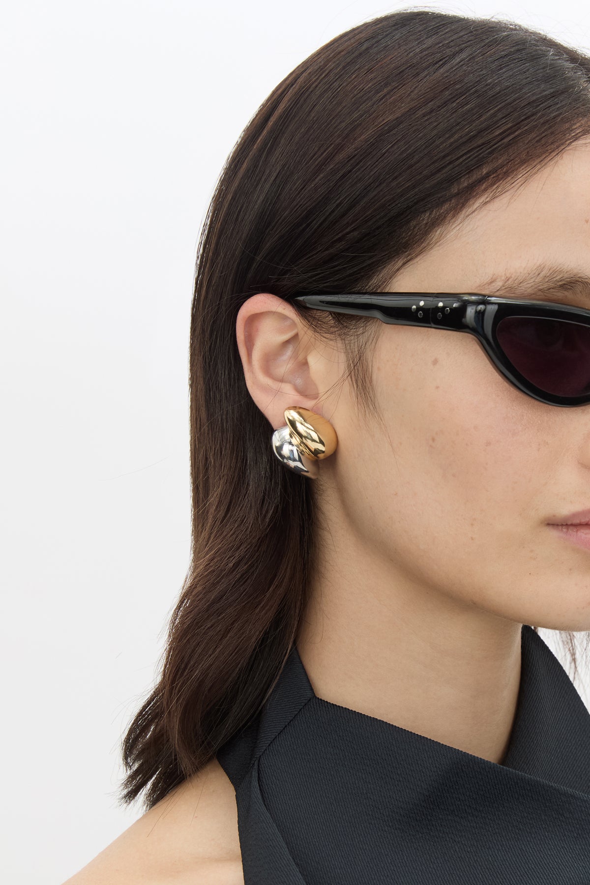 Styled view CAMILLA AND MARC Koa Earrings in sculptural two‑tone 18k gold and rhodium plating.  