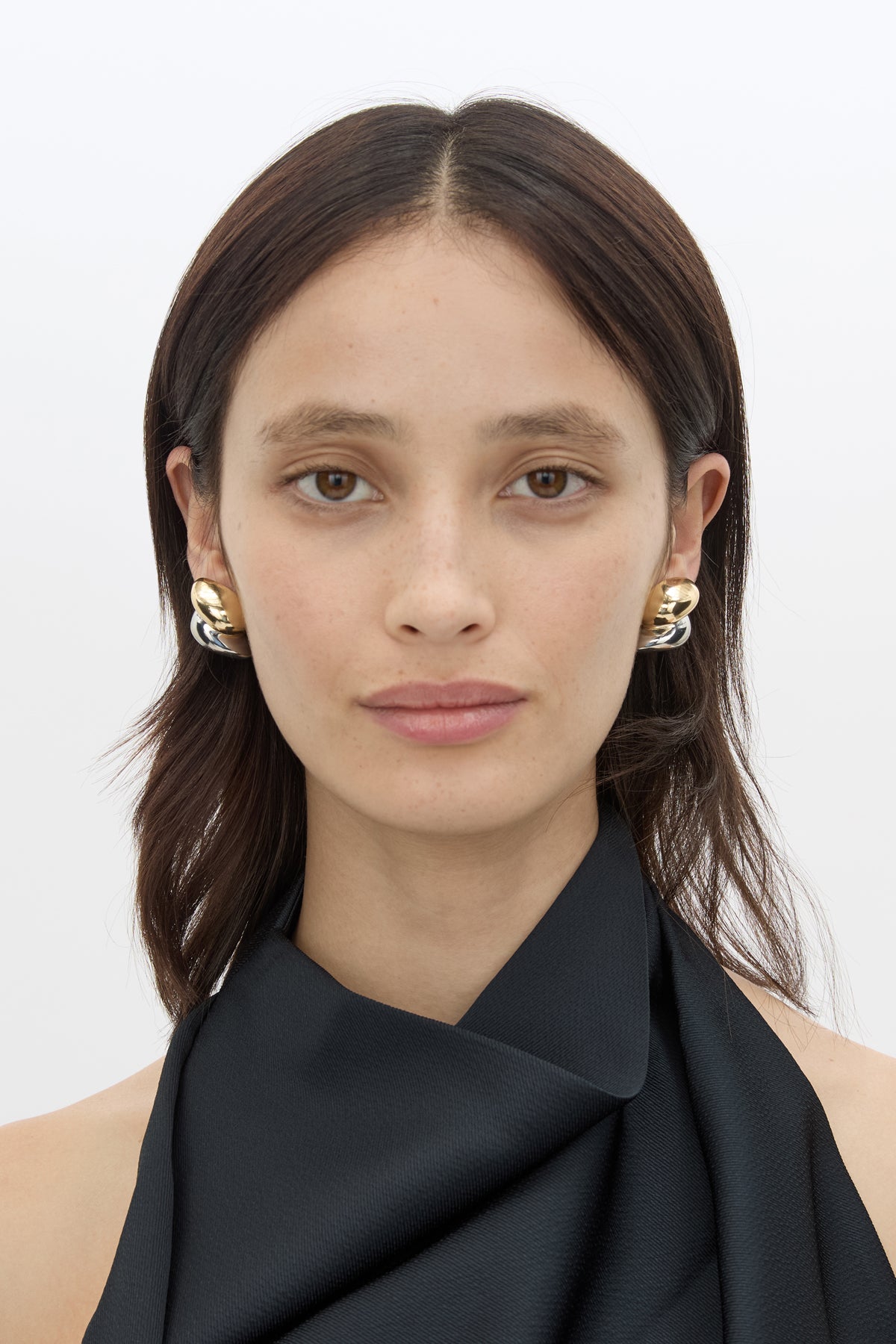 Front styled view CAMILLA AND MARC Koa Earrings in sculptural two‑tone 18k gold and rhodium plating.  
