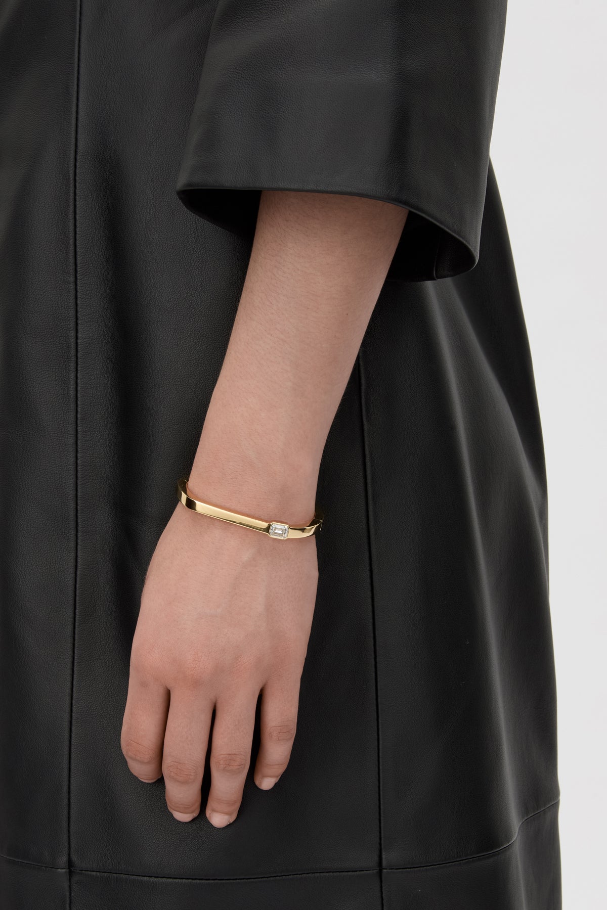 Styled view CAMILLA AND MARC Leighton Bangle with emerald cut cubic zirconia stone.