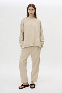 Front view CAMILLA AND MARC Lloyd Sweater in Cream with a ribbed turtleneck and an embroidered chest monogram.